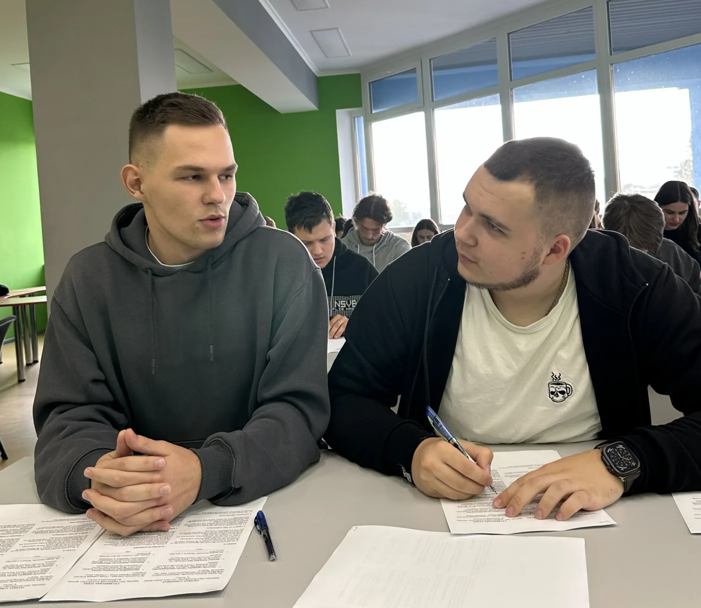Two kood/Zhytomyr students talking through a task together